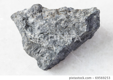 unpolished gray Basalt rock on white marble unpolished gray Basalt rock on white marble 69569253