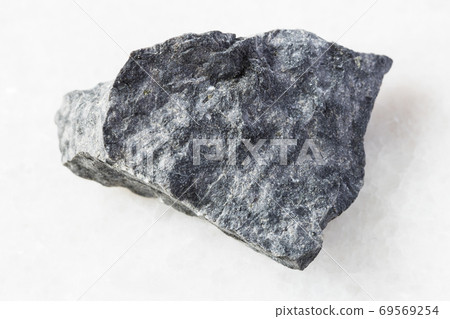 rough gray Basalt rock on white marble 69569254