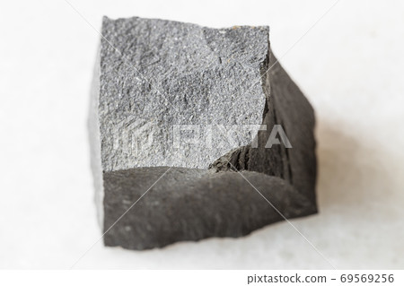 rough Hyalobasalt rock on white marble rough Hyalobasalt rock on white marble 69569256