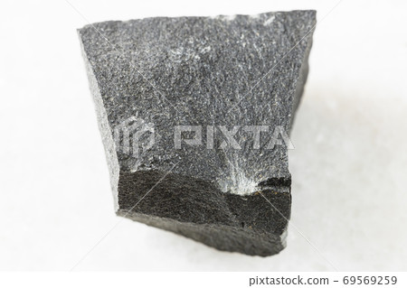 unpolished Hyalobasalt rock on white marble unpolished Hyalobasalt rock on white marble 69569259