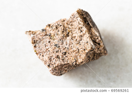 rough Aplite rock on white marble 69569261