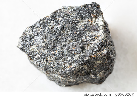 rough Nepheline Syenite rock on white marble rough Nepheline Syenite rock on white marble 69569267