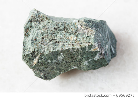 rough Tinguaite rock on white marble 69569275