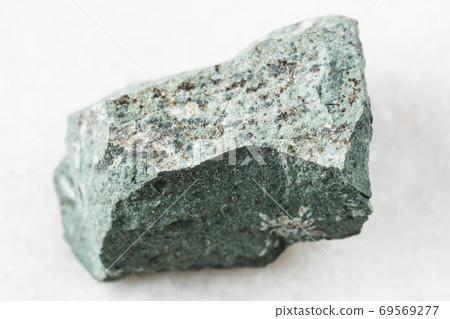raw Tinguaite rock on white marble raw Tinguaite rock on white marble 69569277