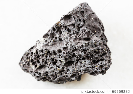 unpolished black Pumice rock on white marble 69569283
