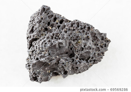 rough black Pumice rock on white marble 69569286
