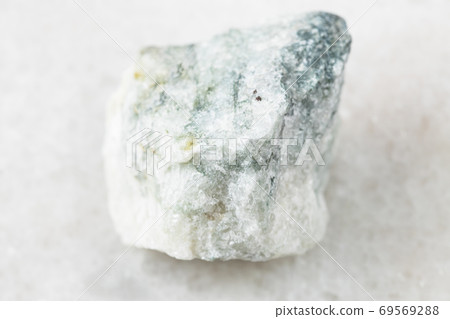 rough Carbonatite rock on white marble rough Carbonatite rock on white marble 69569288