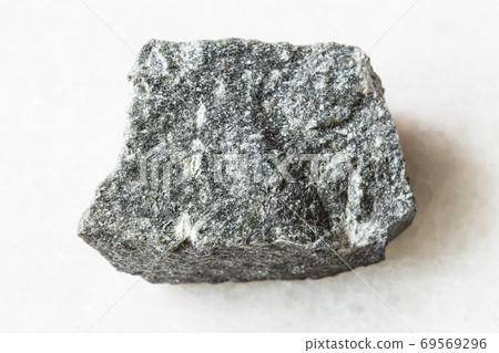 unpolished Andesite rock on white marble 69569296