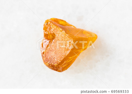 piece of Amber gemstone on white marble piece of Amber gemstone on white marble 69569333