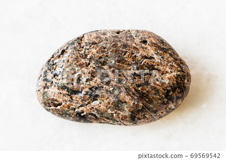 tumbled Titanite (Sphene) rock on white marble tumbled Titanite (Sphene) rock on white marble 69569542