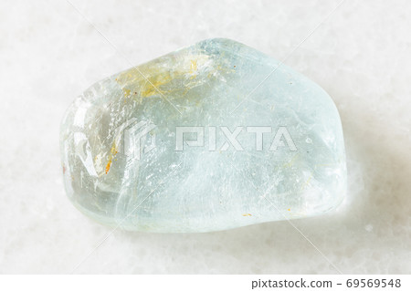 tumbled blue Topaz rock on white marble tumbled blue Topaz rock on white marble 69569548