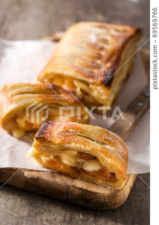 Traditional homemade apple strudel on wooden table Traditional homemade apple strudel on wooden table 69569766