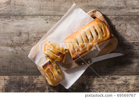 Traditional homemade apple strudel on wooden table Traditional homemade apple strudel on wooden table 69569767
