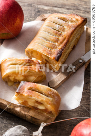 Traditional homemade apple strudel on wooden table	 69569769