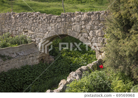 A fragment of medieval masonry around the overgrown creek on the Peninsula of Crimea A fragment of medieval masonry around the overgrown creek on the Peninsula of Crimea 69569968