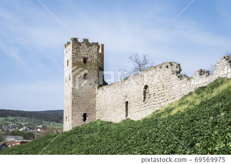 Medieval wall and tower of Genoese fortress in the city of Feodosia on the Crimean Peninsula, built by colonists from Genoa in the 14th century 69569975