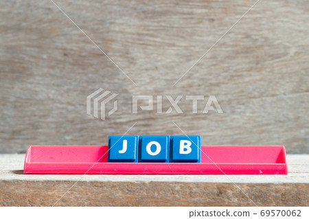 Tile letter on red rack in word job on wood background Tile letter on red rack in word job on wood background 69570062