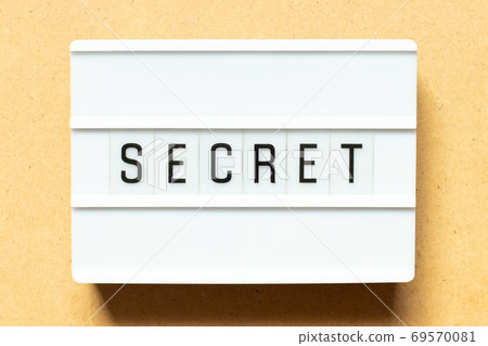 Lightbox with word secret on wood background 69570081