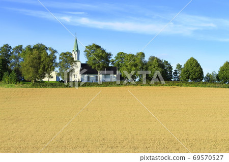 Beautiful summer landscape with Catholic church on endless wheat field 69570527