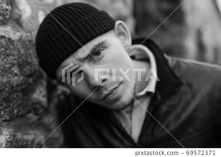 Bully criminal in black leather jacket. Black and white photo Bully criminal in black leather jacket. Black and white photo 69572371
