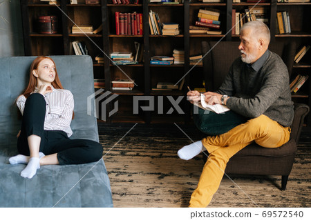 Successful mature man psychologist giving advices to patient at psychologist appointment. Successful mature man psychologist giving advices to patient at psychologist appointment. 69572540