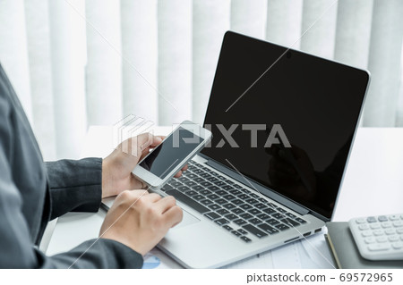 Businesswoman analysis the chart with laptop at the office for setting challenging business goals Businesswoman analysis the chart with laptop at the office for setting challenging business goals 69572965