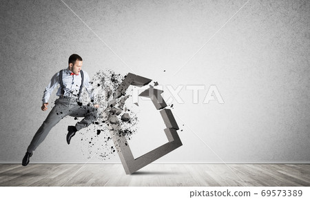 Stone home silhouette as symbol for real estate insurance crashed by man 69573389