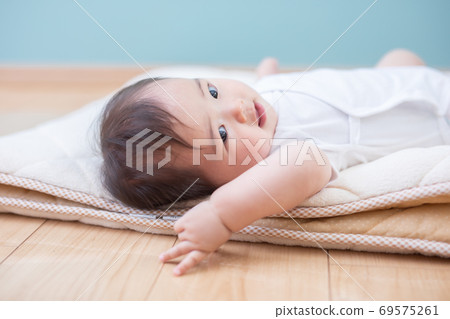 嬰兒躺在他的背上 69575261