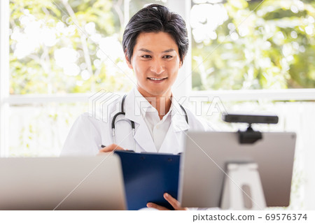 Doctor performing remote examination Doctor performing remote examination 69576374