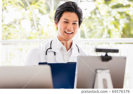 Doctor performing remote examination Doctor performing remote examination 69576376
