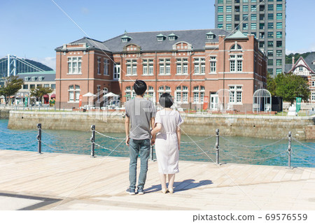 Back view of a couple with their arms crossed Back view of a couple with their arms crossed 69576559