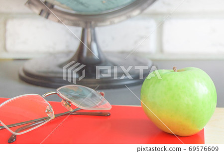 World teachers ' Day in school. Still life with books, globe, Apple, glasses selective focus 69576609