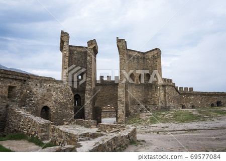 The Eastern Gate Tower of Genoese fortress of the 14th century in the Sudak bay on the Peninsula of Crimea The Eastern Gate Tower of Genoese fortress of the 14th century in the Sudak bay on the Peninsula of Crimea 69577084