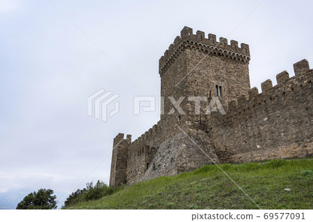 Bottom view of the tower of Genoese fortress of the 14th century in the Sudak bay on the Peninsula of Crimea 69577091