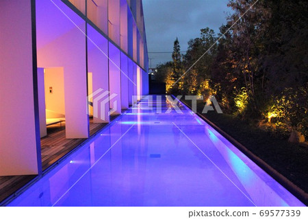 Hotel night pool lit up in fantastic shades 69577339