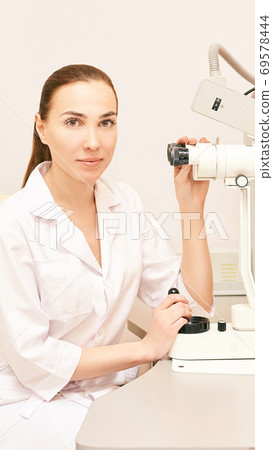 Eye ophthalmologist exam. Eyesight recovery. Astigmatism check concept. Ophthalmology diagmostic device. Beauty girl portrait in clinic 69578444