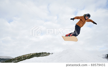 Winter kinds of sport. Skier doing tricks in the mountains in winter season 69579431