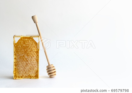 Fresh honey in a mini frame stands on a white background. Reserve vitamins for the winter Fresh honey in a mini frame stands on a white background. Reserve vitamins for the winter 69579798
