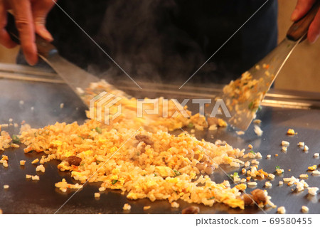 Cooking pilaf on an iron plate Cooking pilaf on an iron plate 69580455