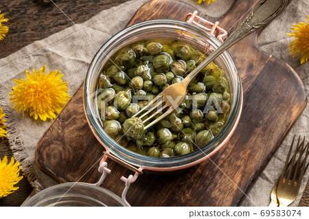 False capers made from young dandelion buds False capers made from young dandelion buds 69583074