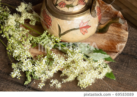 Fresh meadowsweet flowers on a table 69583089