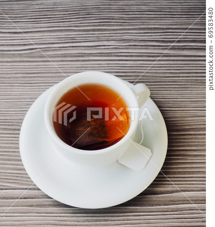 Black tea in a white porcelain cup 69583480