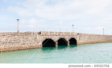 Arrecife Bridge. A stone bridge in the port city of Arrecife on the Spanish island of Lanzarote. Arrecife Bridge. A stone bridge in the port city of Arrecife on the Spanish island of Lanzarote. 69583708