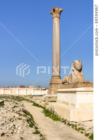 Pompey's Pillar and sphinxes made from red granite stands beside the ruins of the temple of Serapis Pompey's Pillar and sphinxes made from red granite stands beside the ruins of the temple of Serapis 69584967