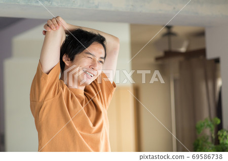 Man doing yoga in the room Man doing yoga in the room 69586738
