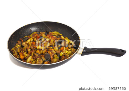 Frying pan with vegetables isolated on white Frying pan with vegetables isolated on white 69587560