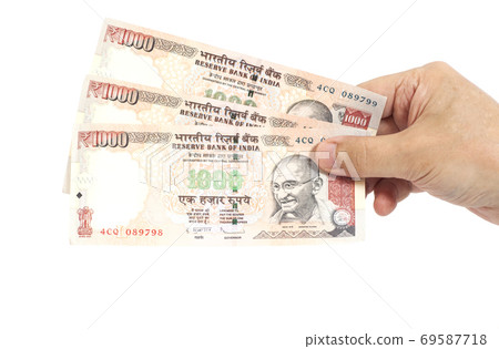 Hand with Indian thousand rupee notes 69587718
