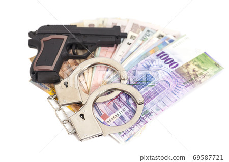 Gun, handcuffs and money isolated on white background 69587721