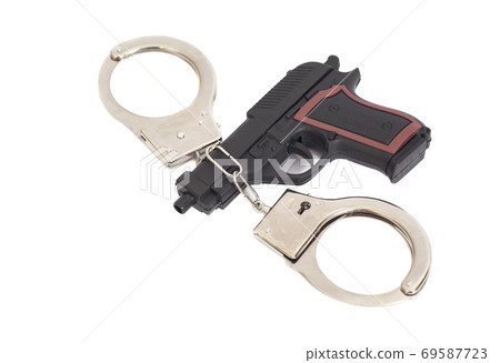 Gun and handcuffs isolated on white background Gun and handcuffs isolated on white background 69587723