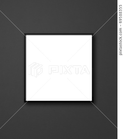Blank square picture frame hanging on a black wall Blank square picture frame hanging on a black wall 69588355